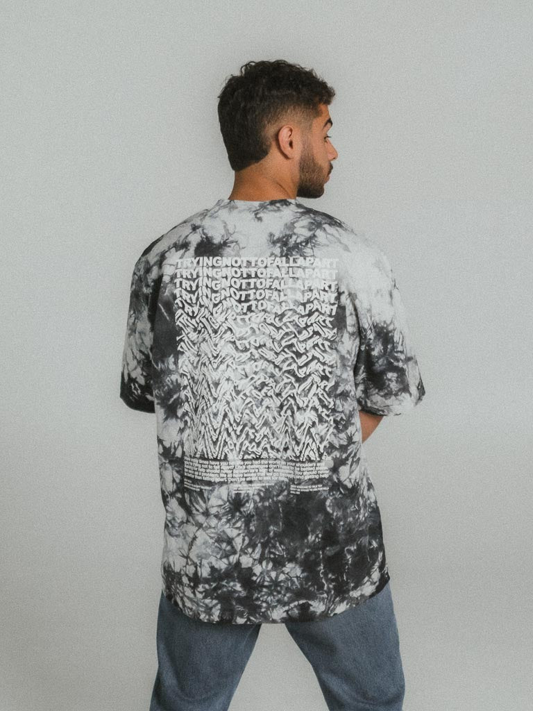 a man wearing a black and white tie dye shirt
