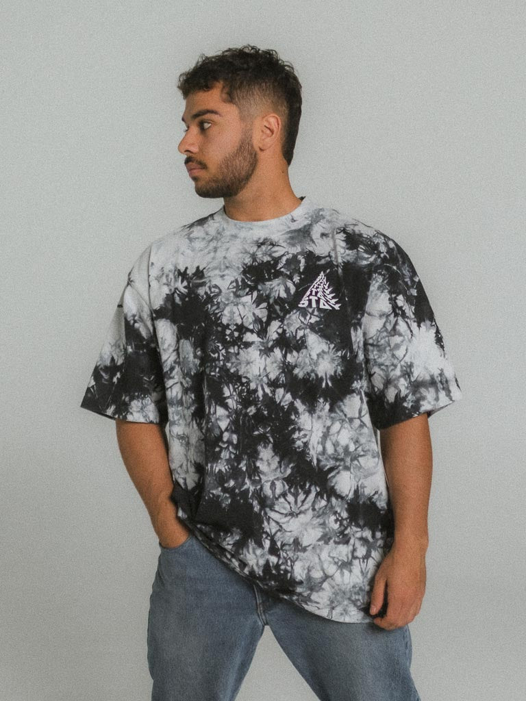a man wearing a black and white tie dye shirt